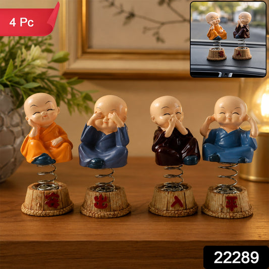 Set of four little monk statues with spring bobble heads