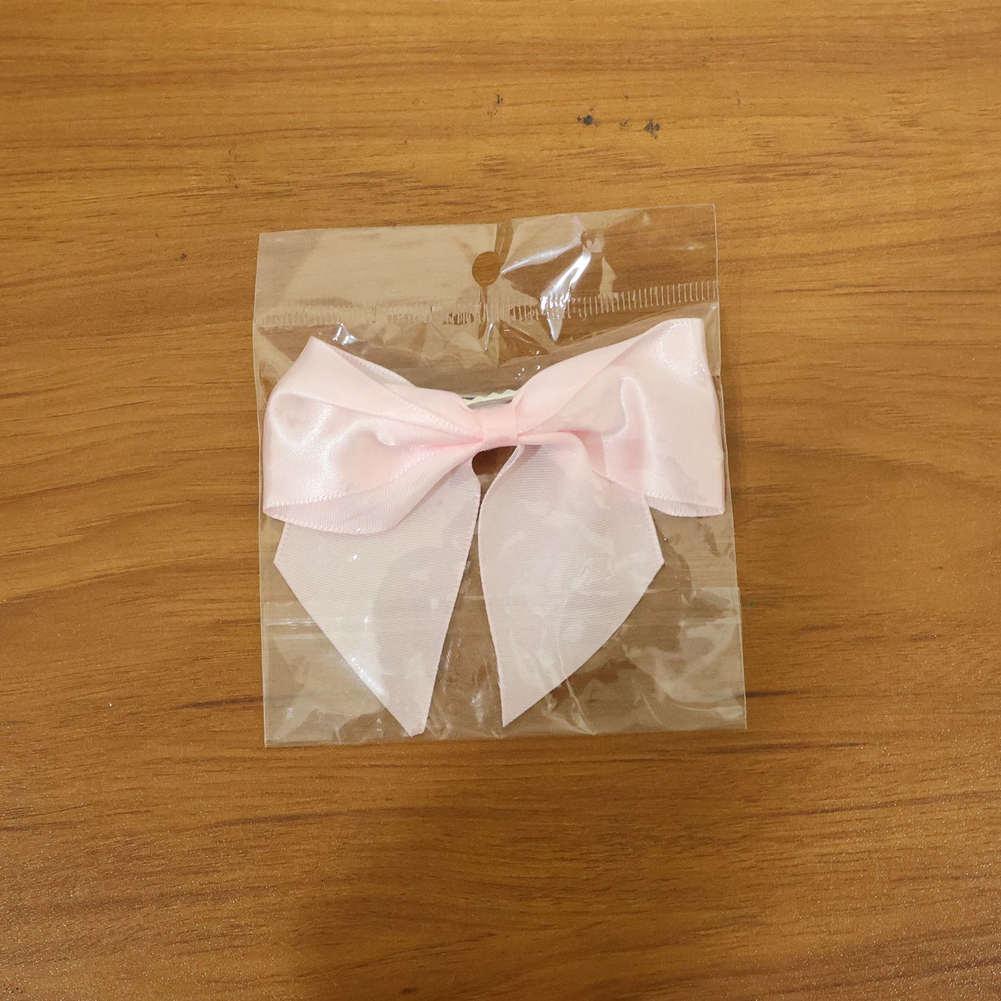 Model wearing satin hair bow clip showcasing stylish hair accessory
