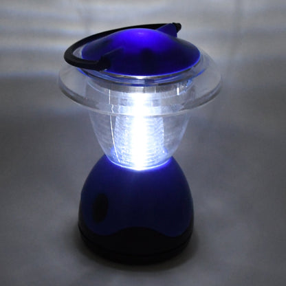 The blue and clear plastic lantern is brightly illuminated, casting a glow on the surrounding gray surface.