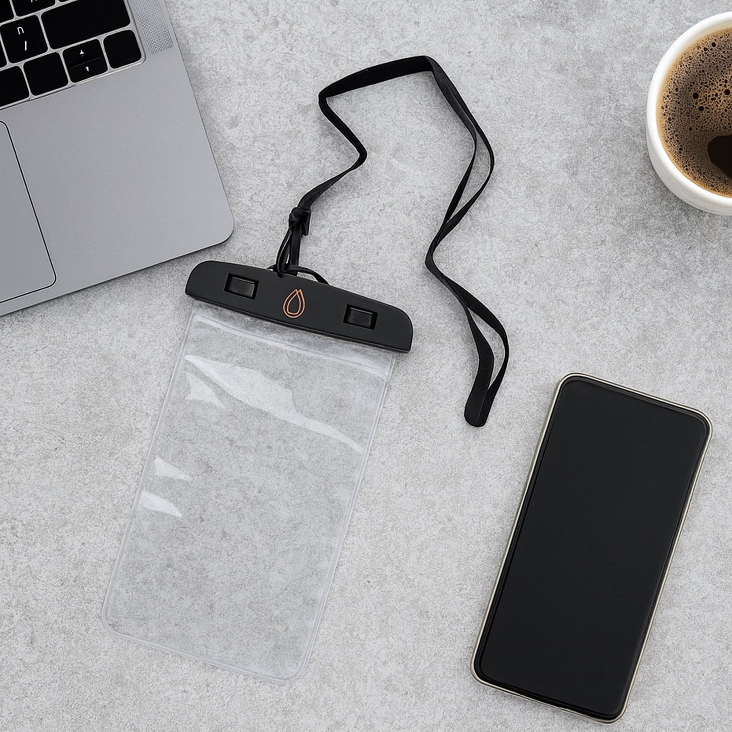 A transparent mobile pouch with a black neck strap and a red droplet logo, next to a laptop, phone, and coffee.