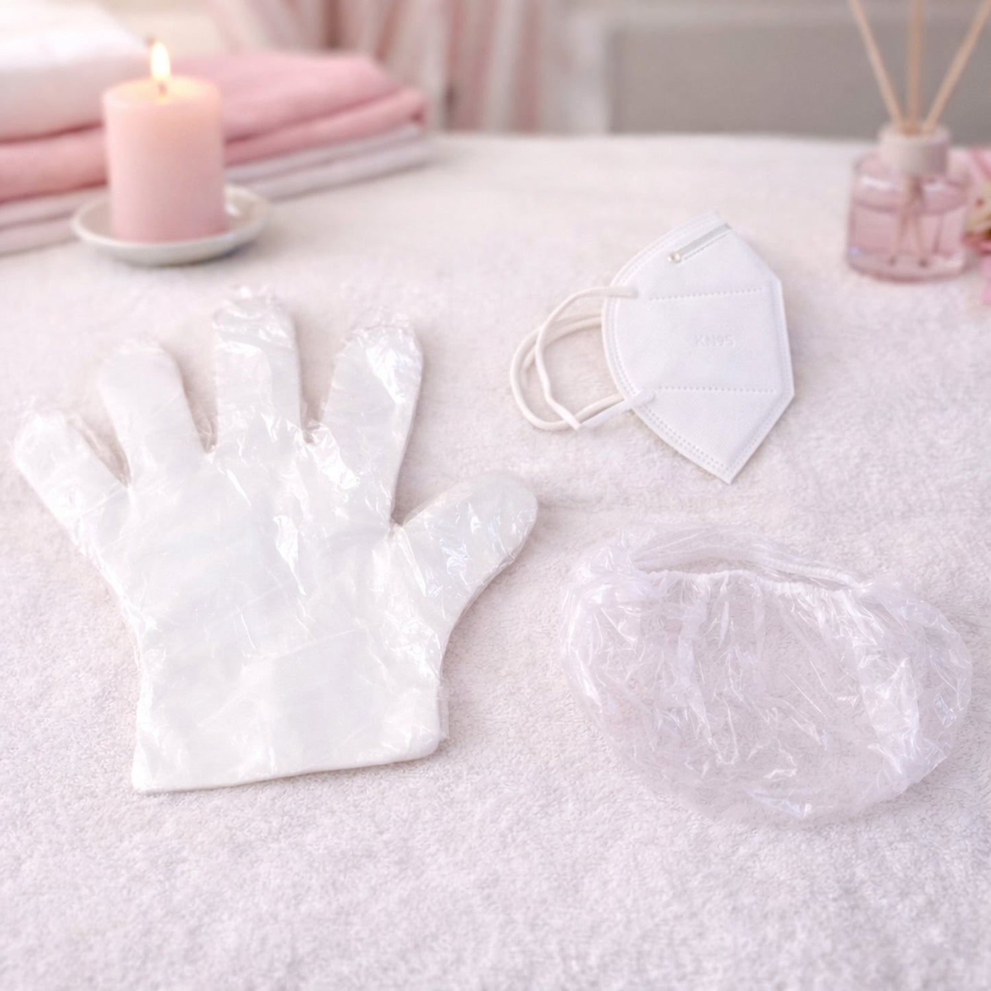 Disposable hygiene safety kit set including gloves, face mask, and shower cap in protective packaging