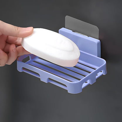 Side profile of the sleek, compact self-adhesive soap holder on a white wall.