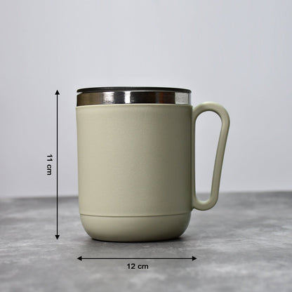 An Indian man enjoying a hot beverage from the Ganesh stainless steel coffee mug.