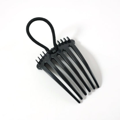 Hair styling comb clip securing hair in a voluminous bun style