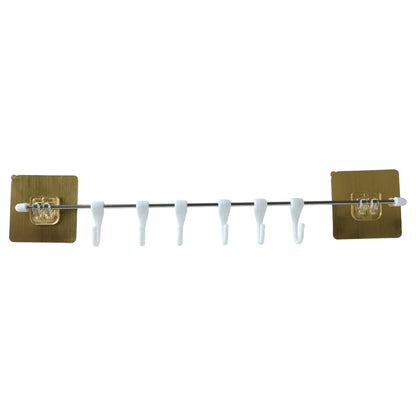 Kitchen hook rack organizer mounted on wall holding utensils and towels