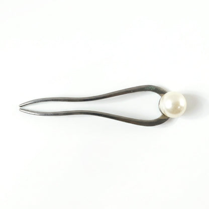 Close-up of pearl hair pin detail