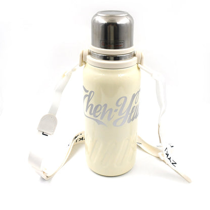 The 1200ML hot and cold water bottle being carried comfortably by its handle.