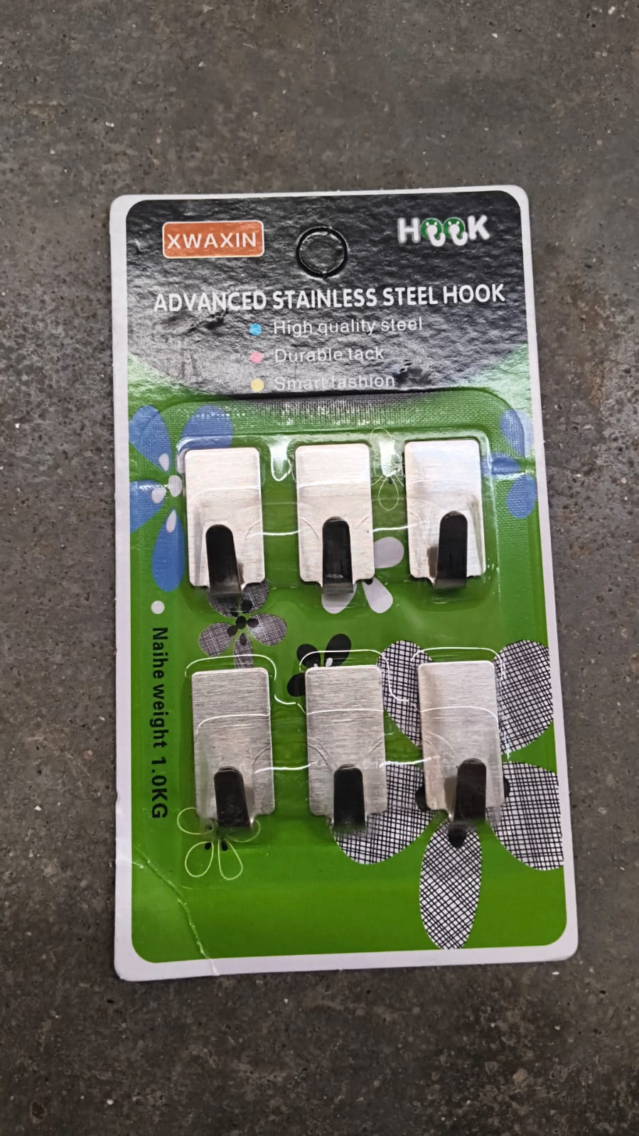 Adhesive wall hooks attached to smooth mounted surface