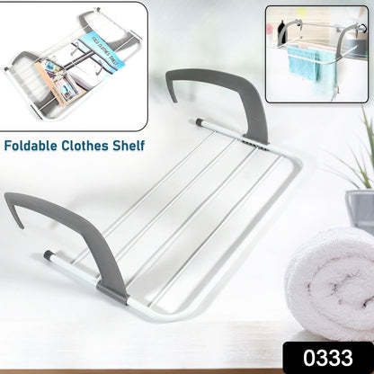 Compact folding drying rack securely attached to a balcony railing, ideal for outdoor use.