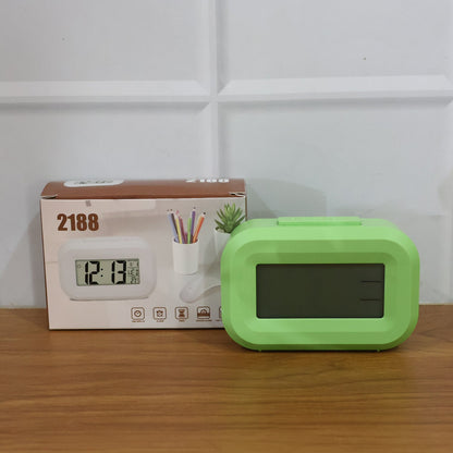 Lifestyle image of digital alarm clock on desk in office space