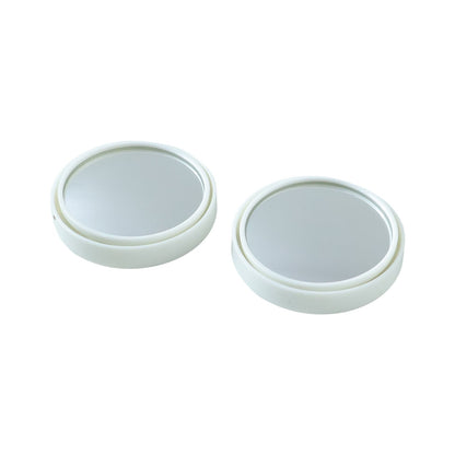 Close-up view of white round car blind spot mirror