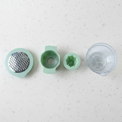Top-down view showing various grating surfaces on manual vegetable grater