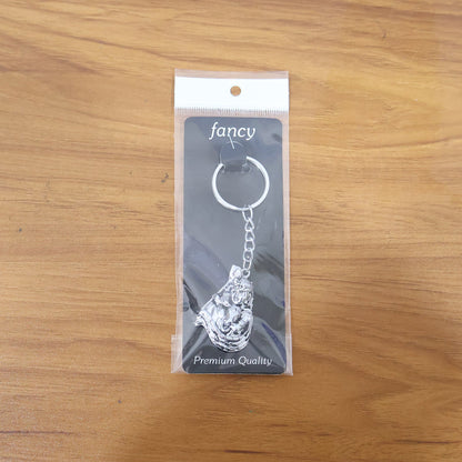 Lifestyle image of silver finish Bal Krishna keychain attached to car keys