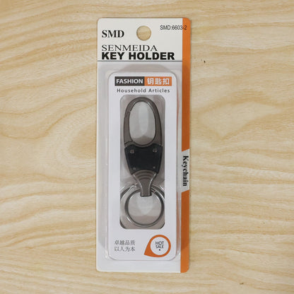 Metal key holder with rotating swivel on plain white background