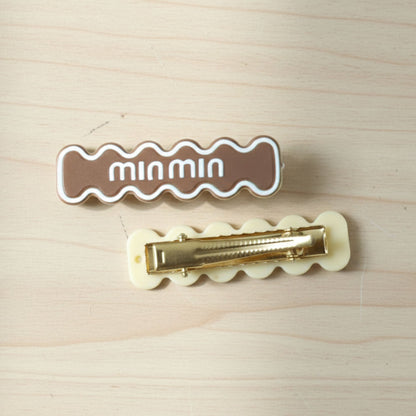 Detailed close-up of secure snap mechanism on wavy hair clip