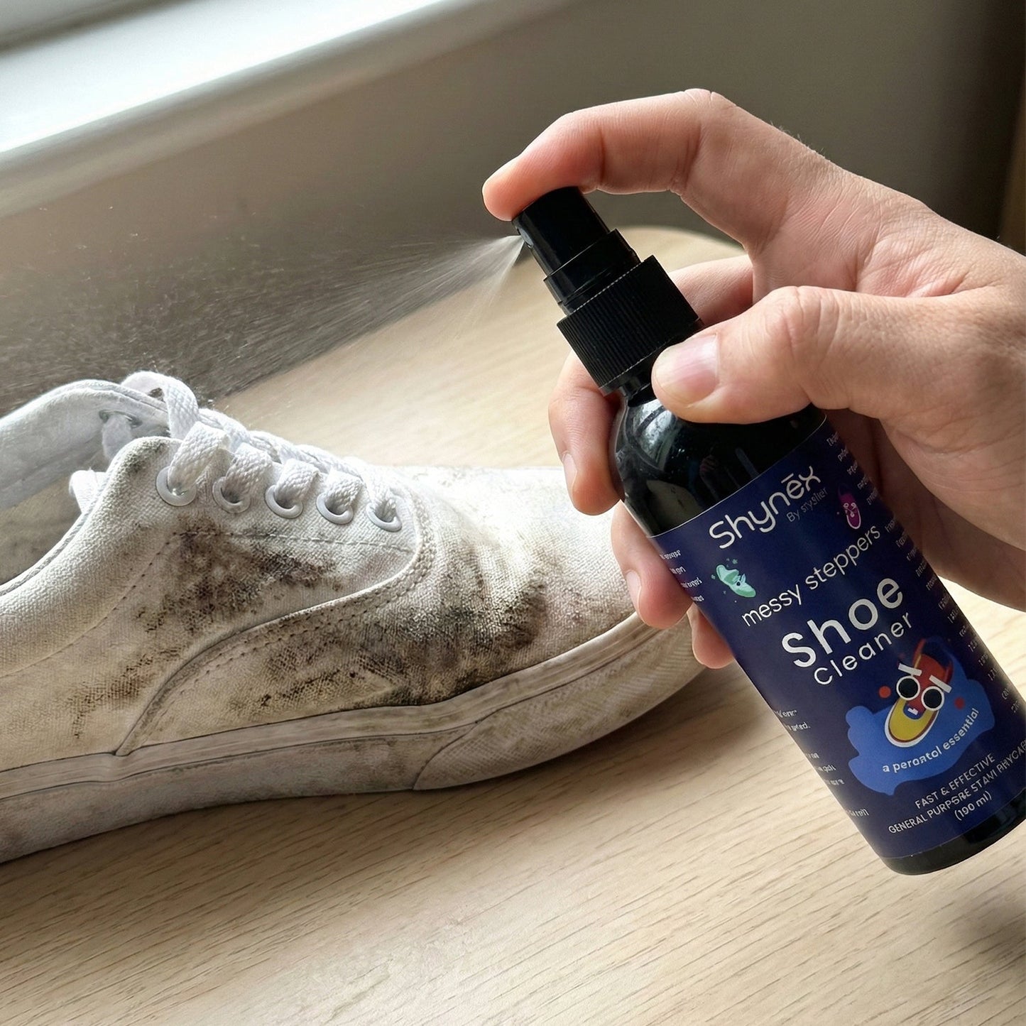 Shoe Cleaner Spray applied on white sneakers to remove stains