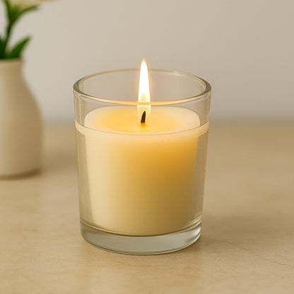 Soy blend scented candle in its elegant clear glass holder.