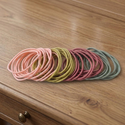 Collection of 40 elastic hair bands in various neutral shades, lightweight for comfort.