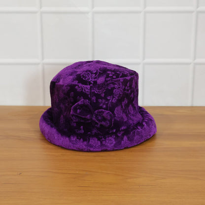 Model wearing velvet floral bucket hat outdoors
